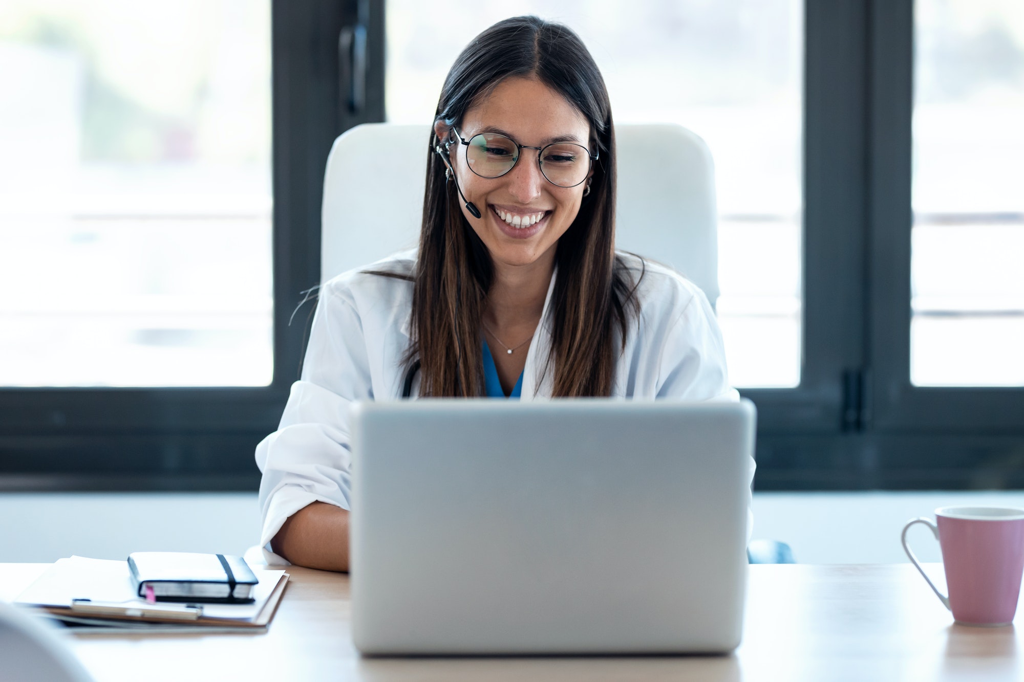 female-doctor-talking-with-colleagues-through-a-video-call-with-a-laptop-in-the-consultation-1-2.jpg female-doctor-talking-with-colleagues-through-a-video-call-with-a-laptop-in-the-consultation-1-2.jpg